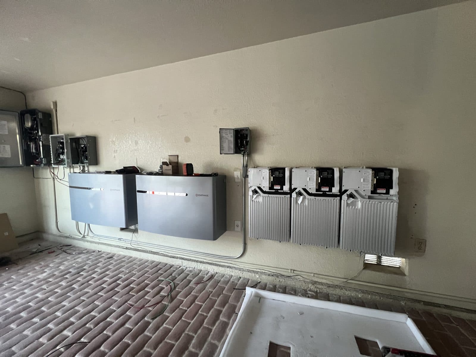 Two Enphase IQ home batteries with power electronics installed in a garage in Palm Springs, CA