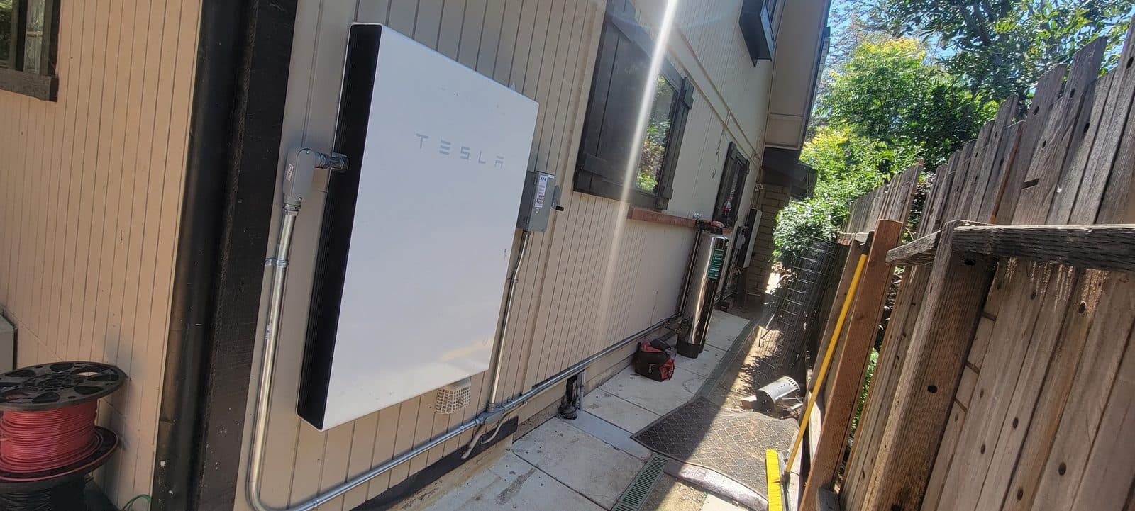 Tesla Powerwall home battery installed on a shaded exterior wall in Simi Valley, CA