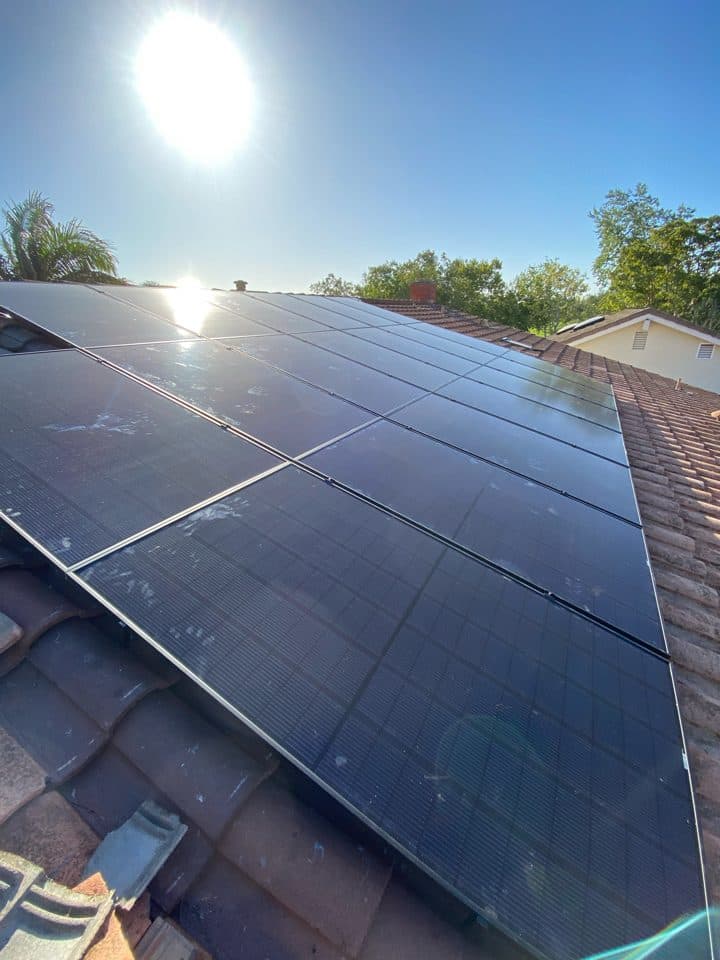 All-black solar panels installed flush on a Spanish tile roof in Costa Mesa, CA