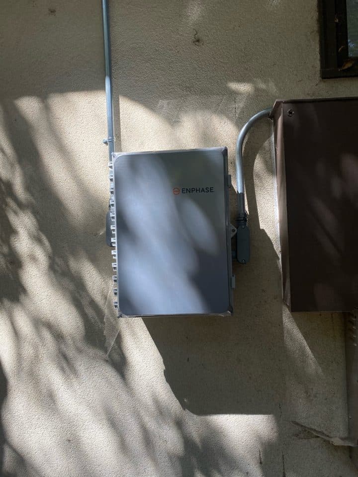 Enphase IQ combiner and clean conduit runs on a stucco wall in Topanga, CA